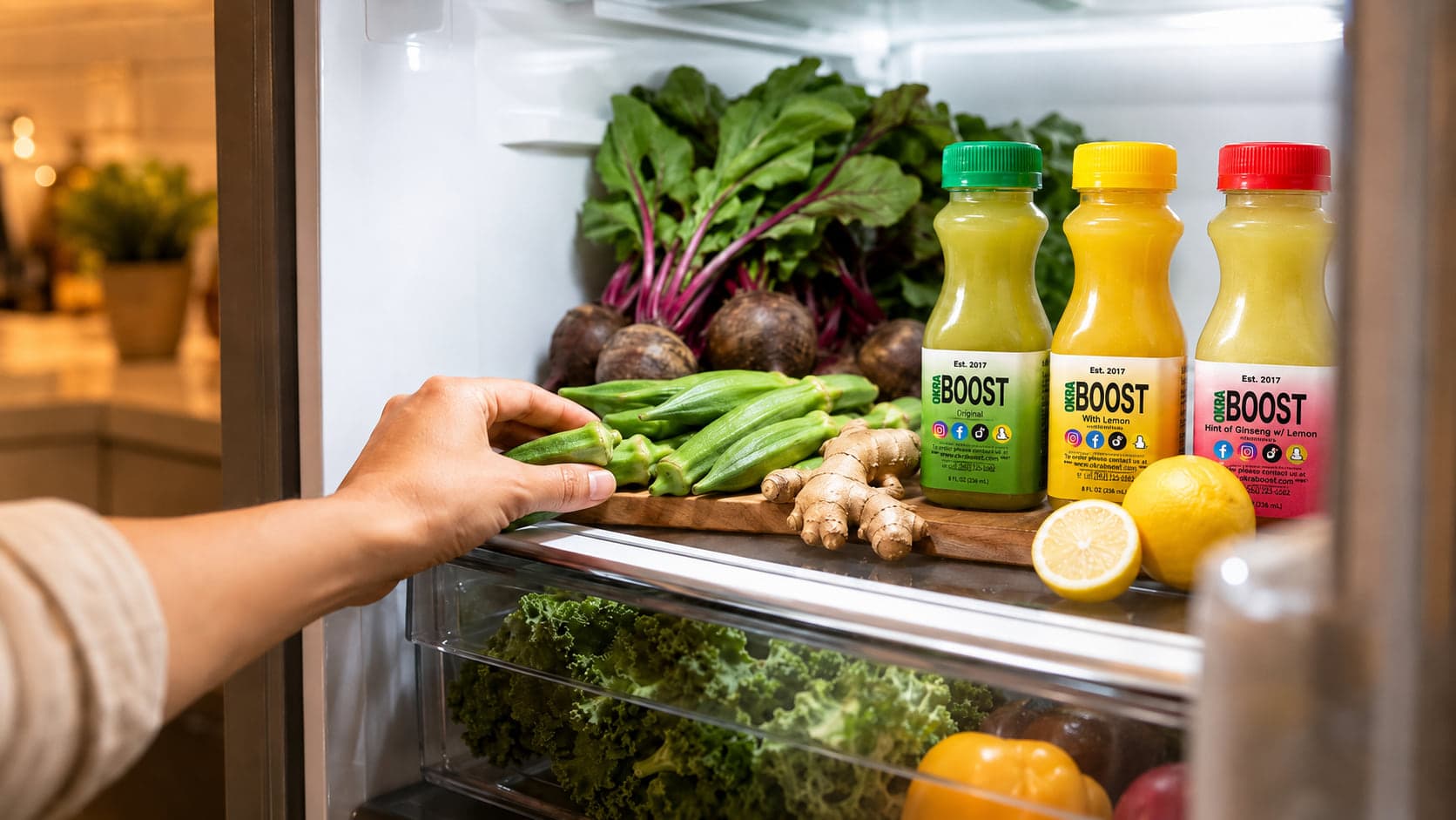 A hand reaches into an open kitchen fridge — fresh greens, lemons, ginger, and beets visible on the shelf, ready to be paired with a daily ritual