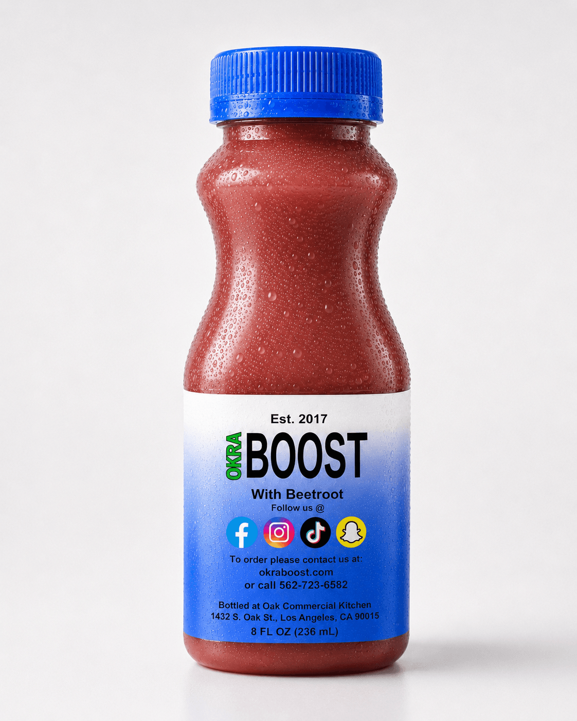 Okra Boost Beetroot: red-cap bottle with deep beet-red liquid, clean white studio backdrop